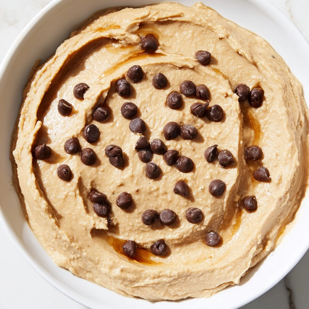This delightful bowl of Chocolate Chip Cookie Dough Hummus shows a simple, quick dessert option.