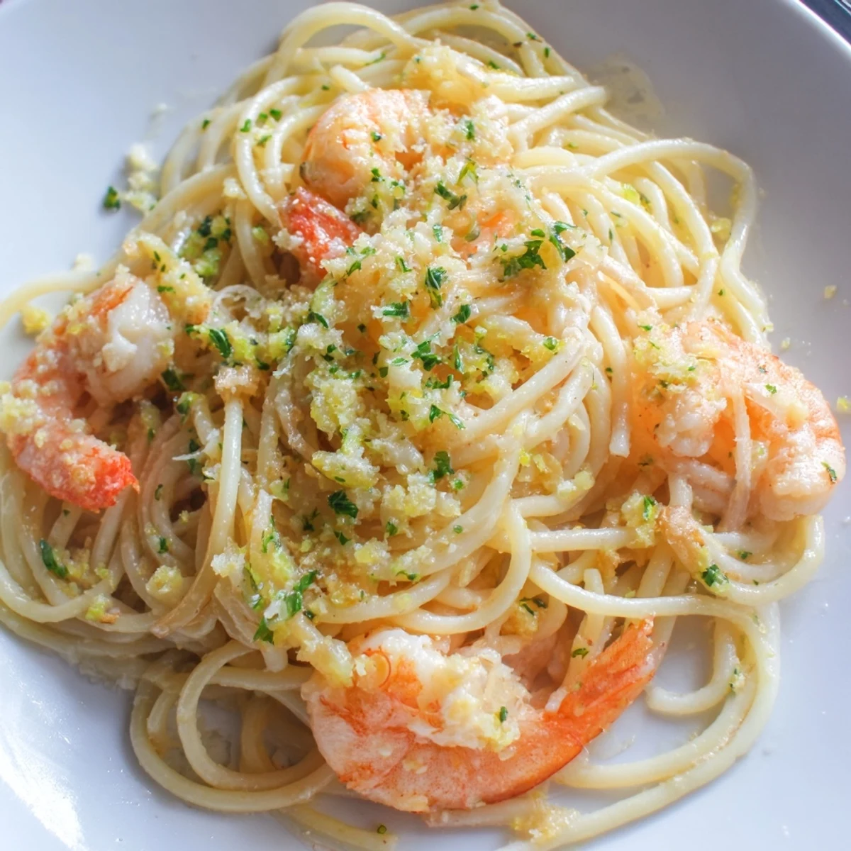 Freshly cooked Lemon Shrimp Pasta with tender shrimp, zesty lemon slices, and parsley in a skillet.