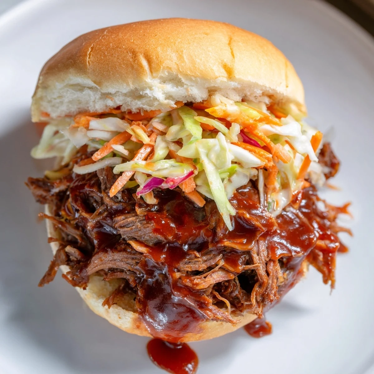 Golden, tender shredded beef shoulder, slow-cooked and tossed in rich BBQ sauce for a juicy sandwich.