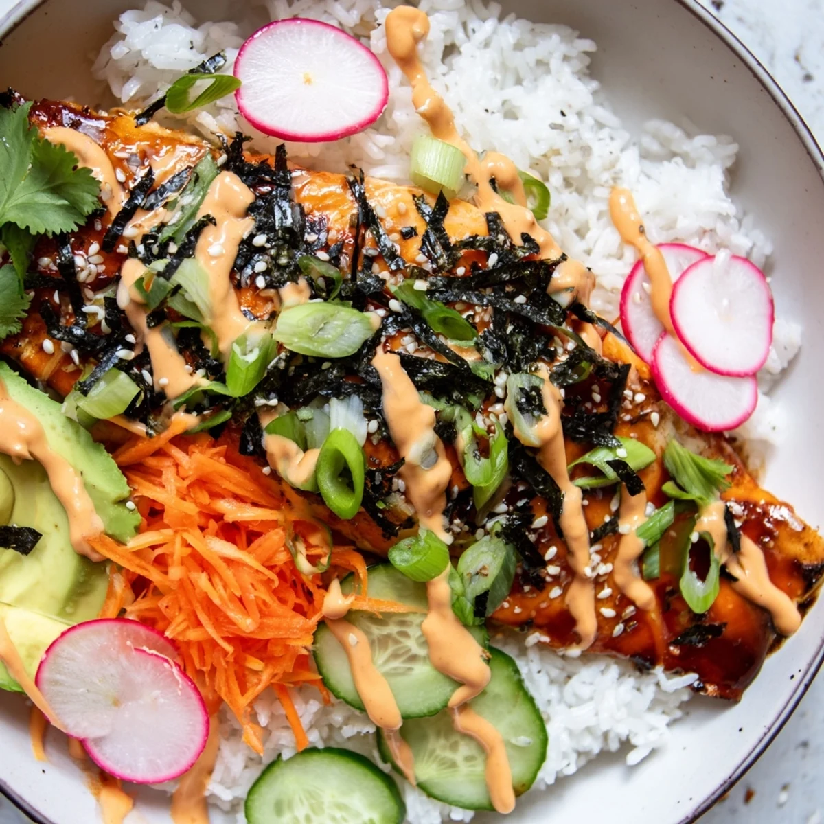 Flaky teriyaki salmon atop fluffy jasmine rice with vibrant quick-pickled veggies in these delicious taco bowls.
