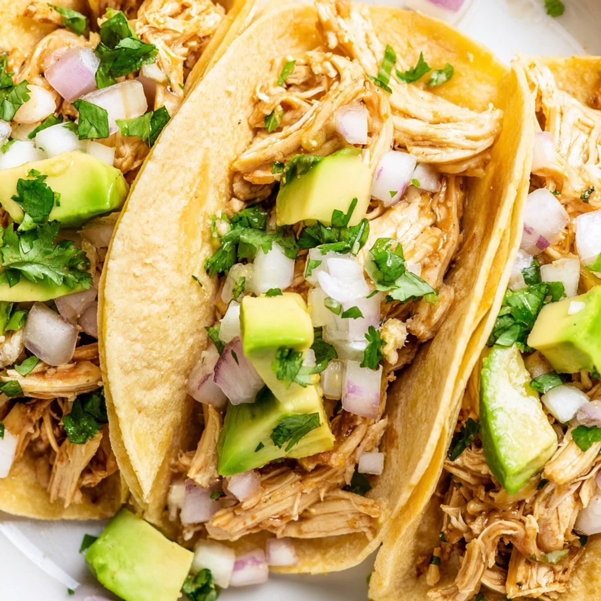 Juicy seasoned chicken, diced and piled into warm corn tortillas with cilantro, onion, and avocado for Chicken Street Tacos.