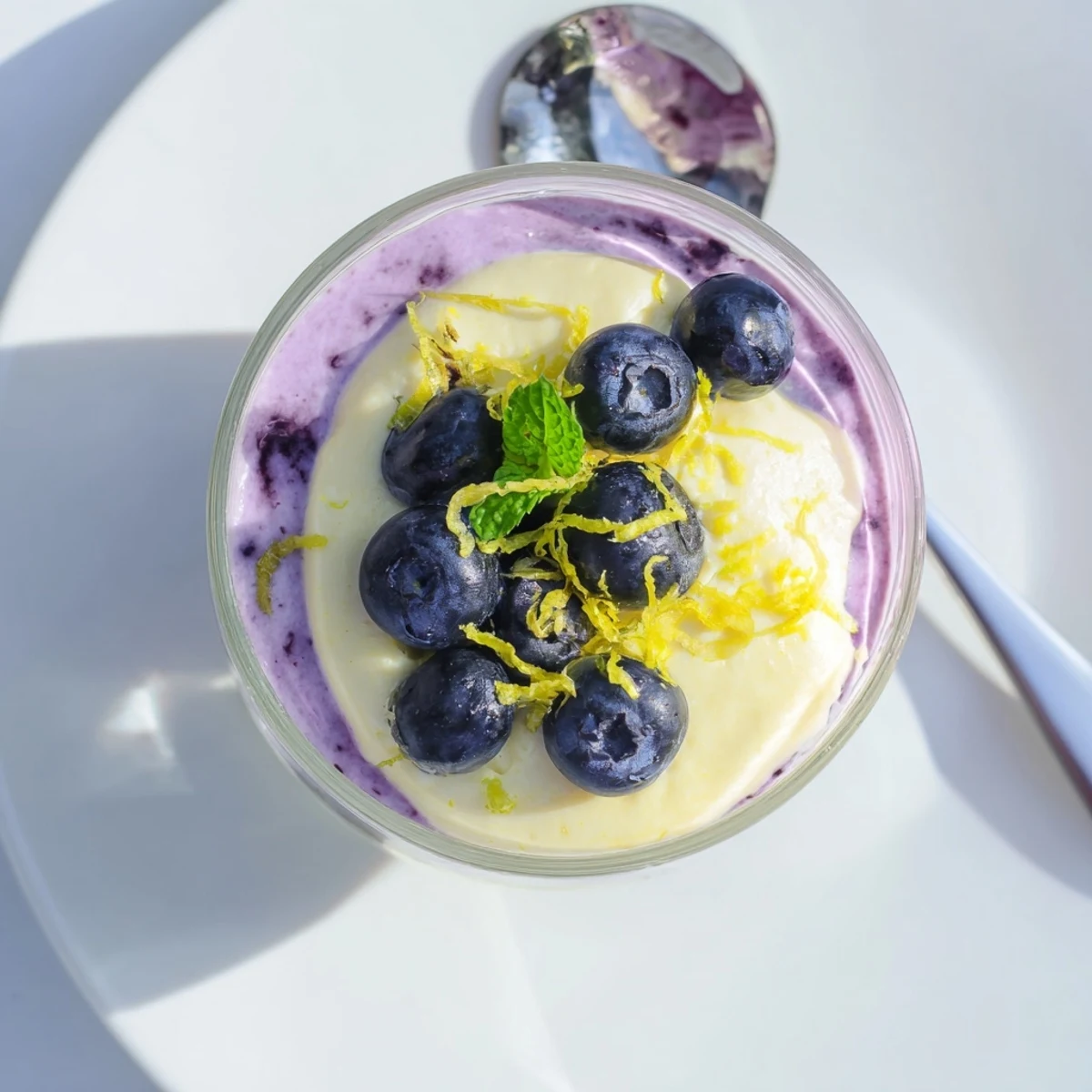 Chilled Lemon Blueberry Mousse with blueberry compote layers and a light, airy texture.