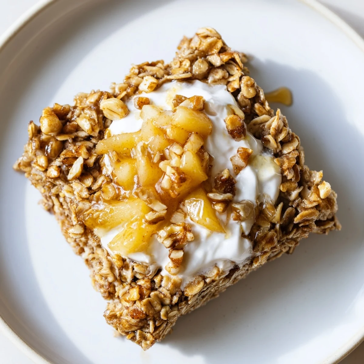 Serve this comforting Baked Apple Oatmeal With Greek Yogurt for a wholesome American breakfast or brunch.