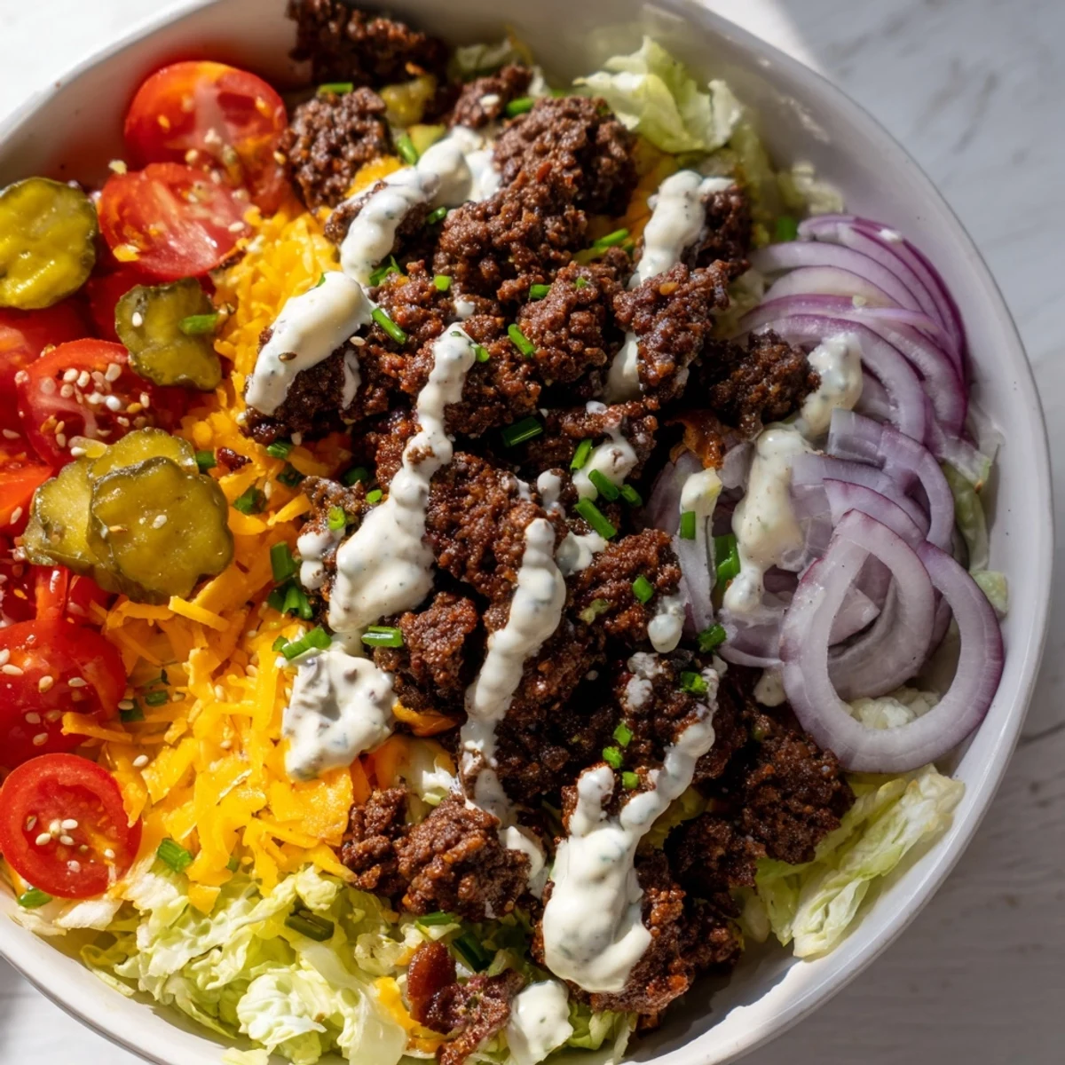 Smash Burger Bowl with juicy ground beef, fresh tomatoes, onions, and a creamy drizzle, ready to eat.