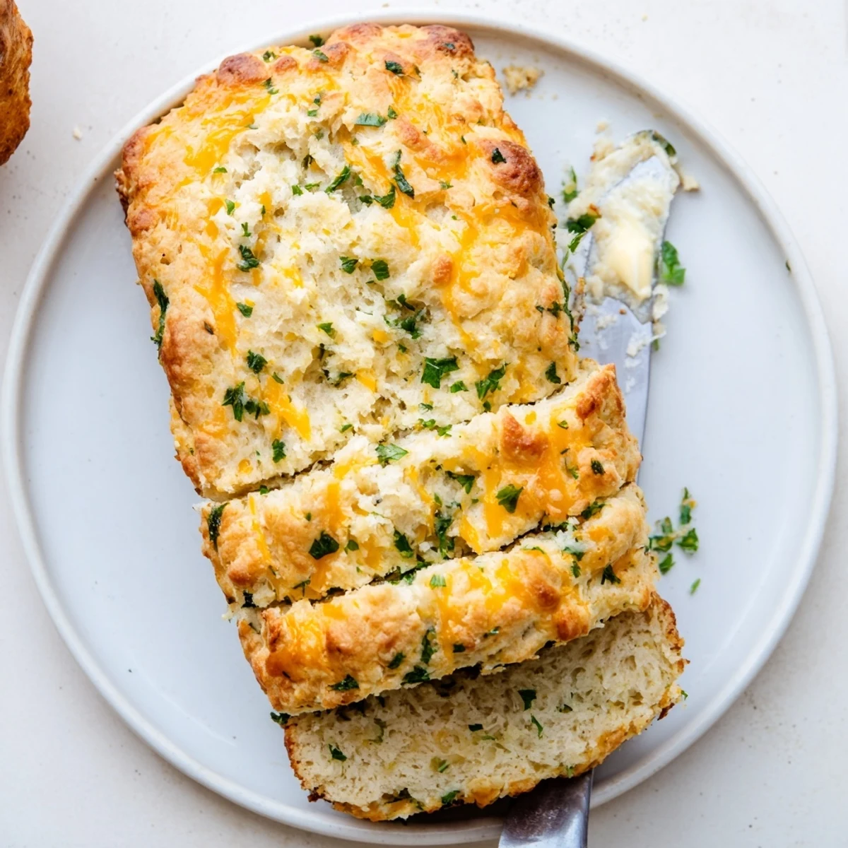 Freshly baked Red Lobsters Cheddar Bay Biscuit Loaf with golden crust and garlic butter topping on a rustic board.