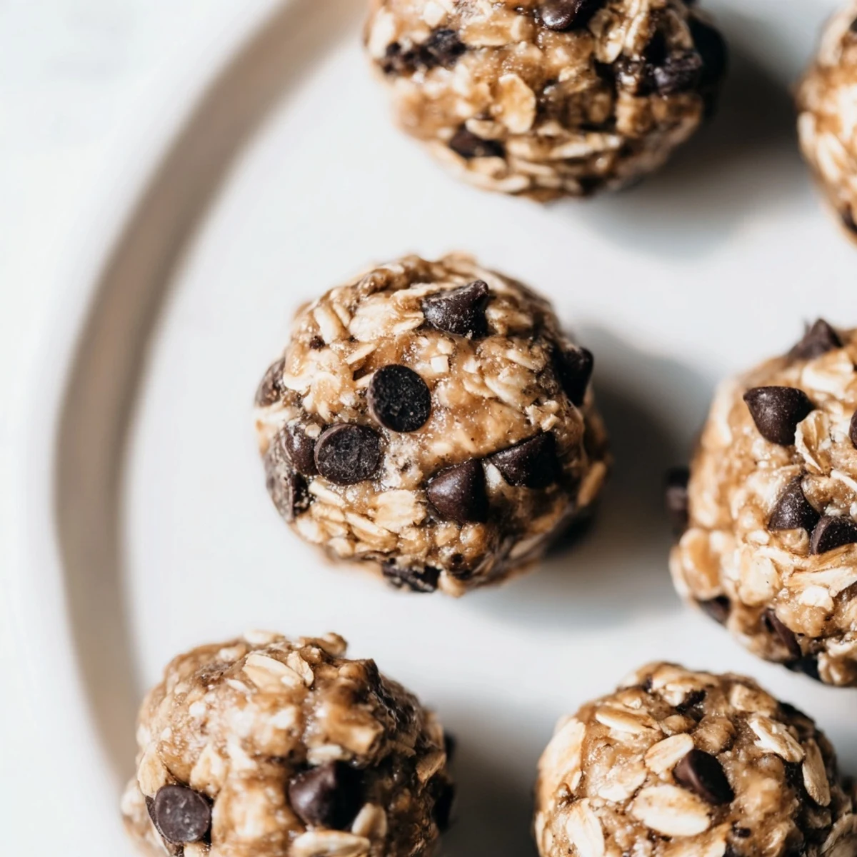 Close-up view of Mint Chocolate Chip Protein Balls, showing chocolate chips and a cool minty green hue for healthy snacking.