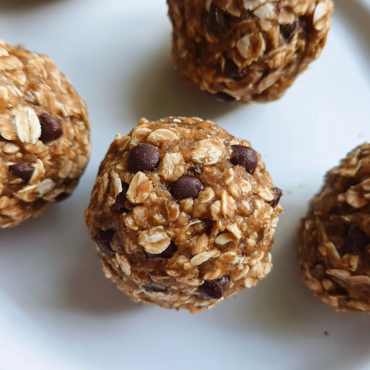 Twelve mint protein balls arranged on a tray, ready to be refrigerated and enjoyed as a gluten-free dessert.