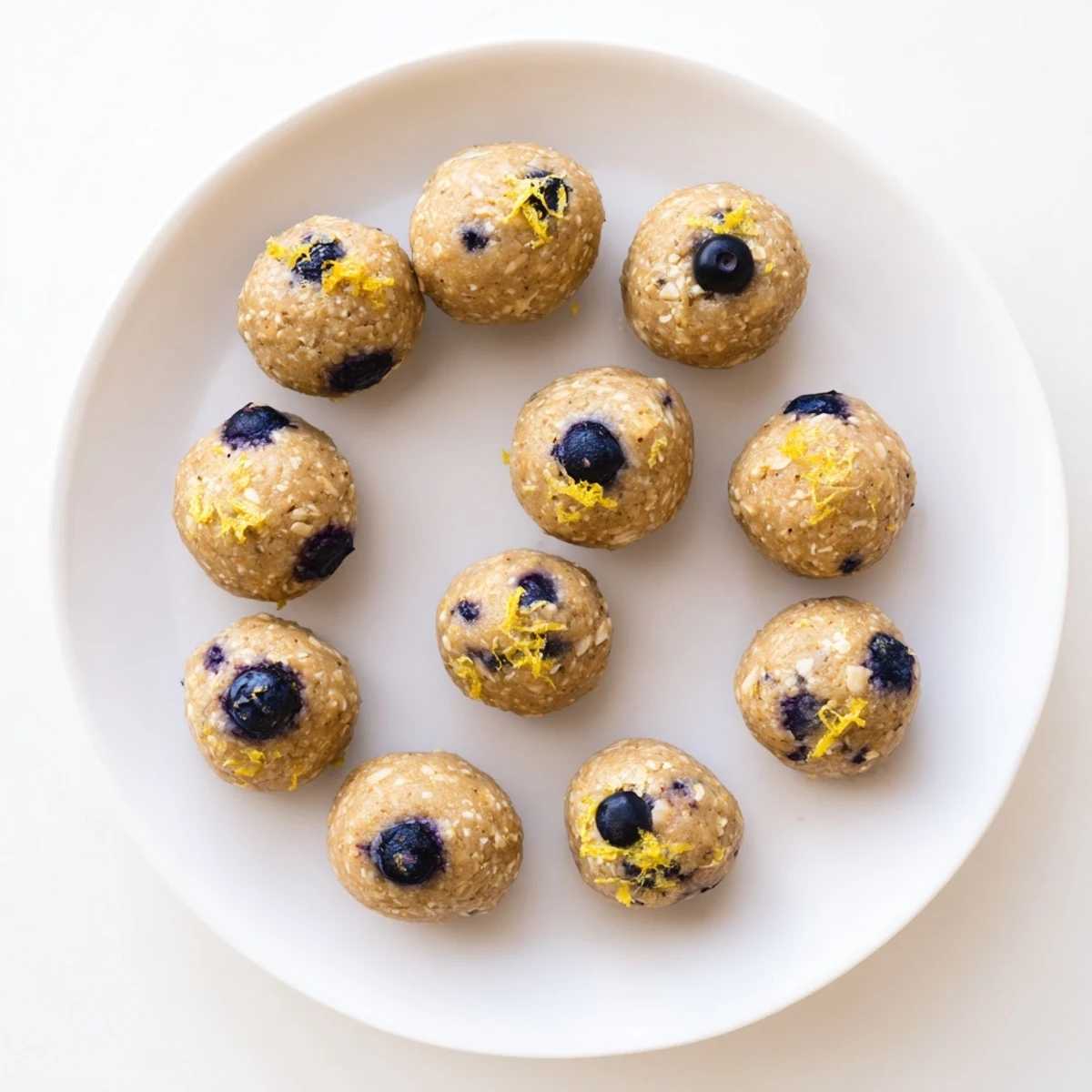 Blueberry Cheesecake Protein Bites are round, no-bake bites topped with fresh blueberries and a creamy texture.