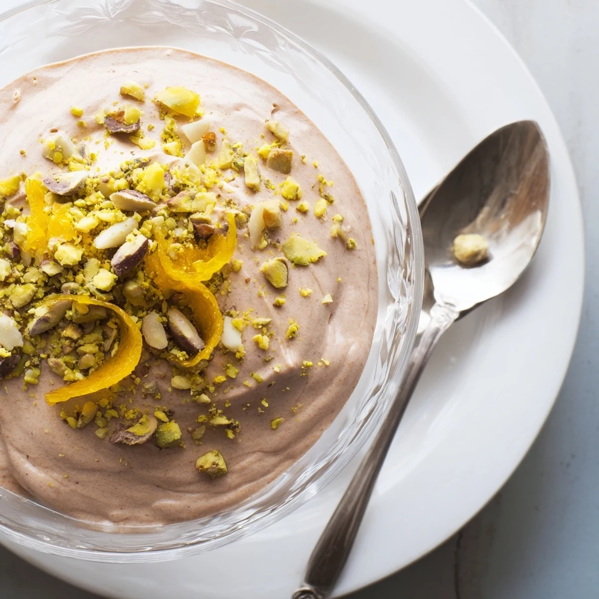 Creamy Lebanese Date Orange Blossom Mousse garnished with pistachios and orange zest.