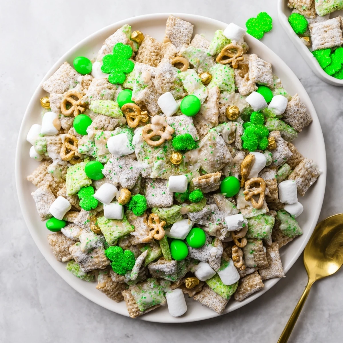 Sweet white chocolate cereal treat sprinkled with green M&Ms for a fun St. Patricks Day party dessert