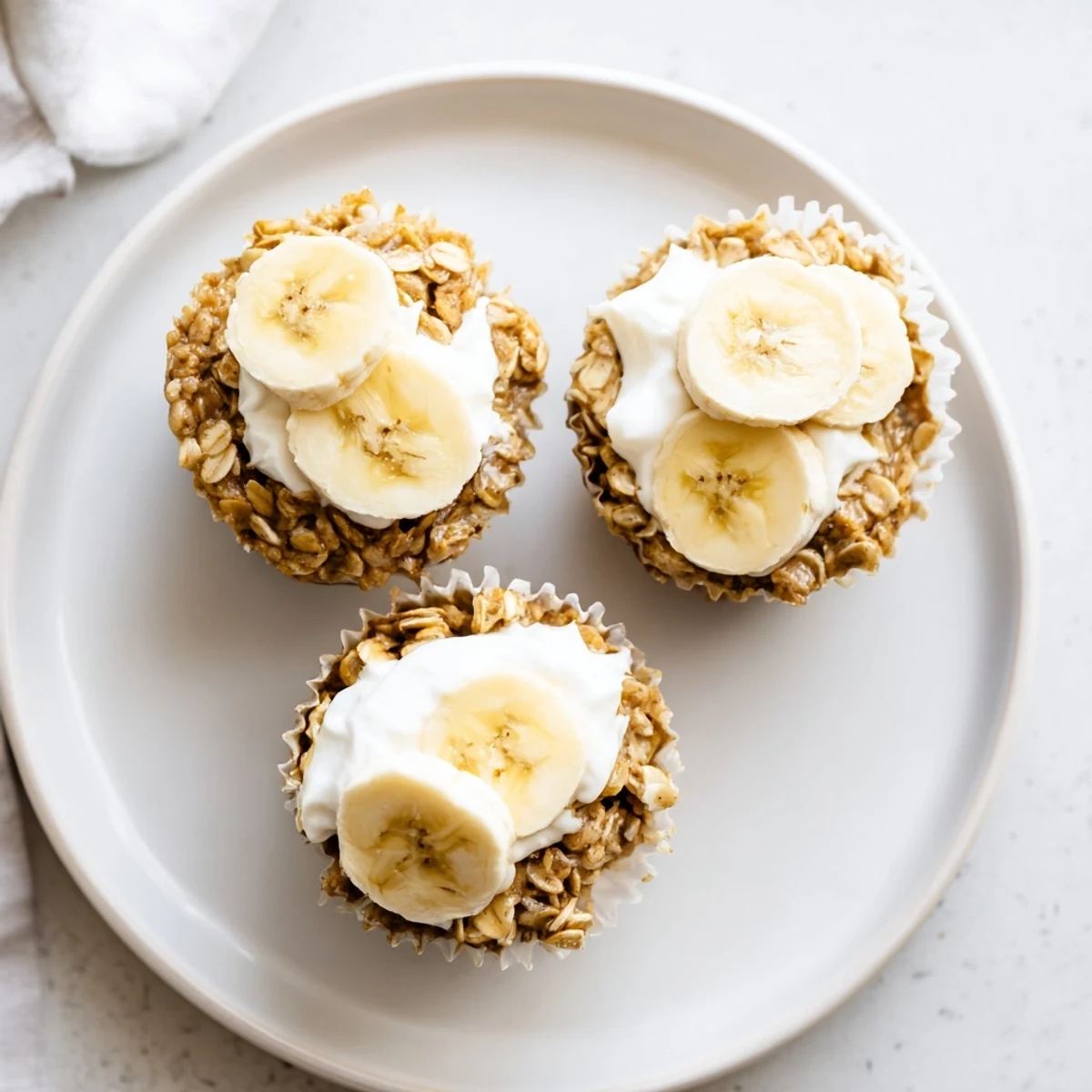 Moist handheld oatmeal cups studded with ripe bananas, warm cinnamon, and optional walnuts