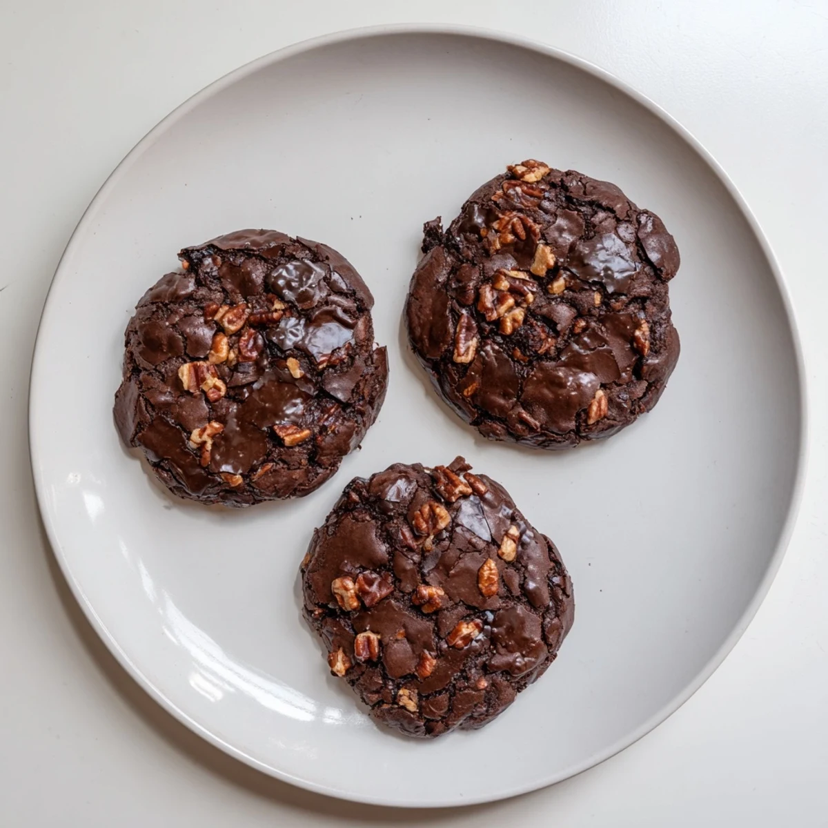 Rich chocolate sourdough brownie cookies cooling on a wire rack after baking