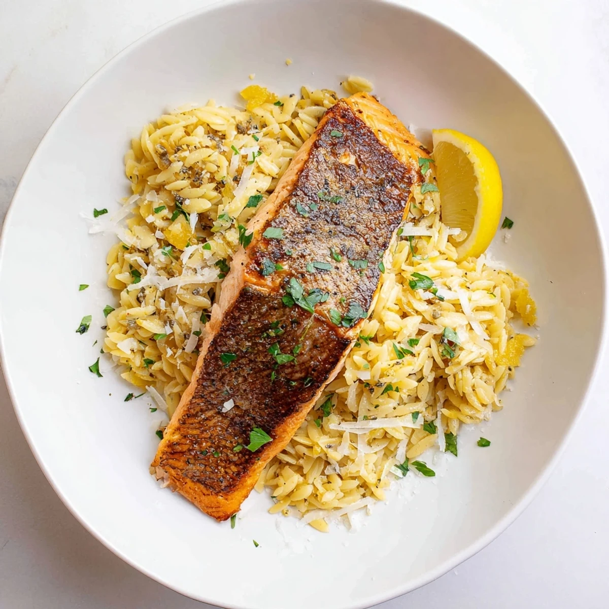 One skillet salmon with lemon orzo cooked to tender perfection in a single pan