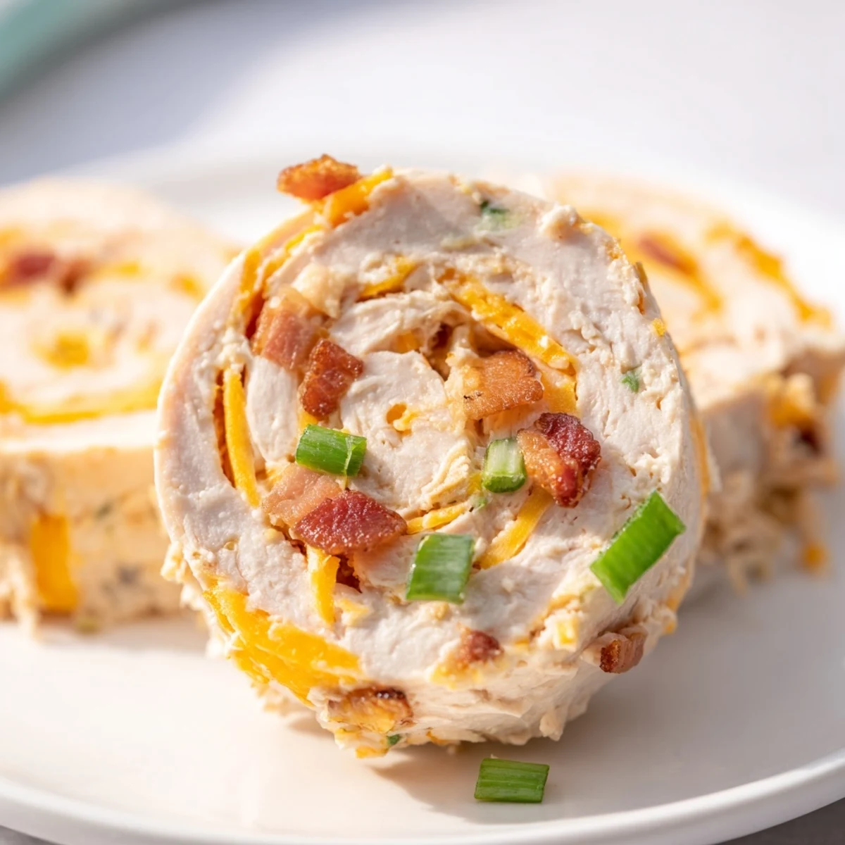 Spiral slices of creamy crack chicken pinwheels filled with bacon, cheddar, and green onions