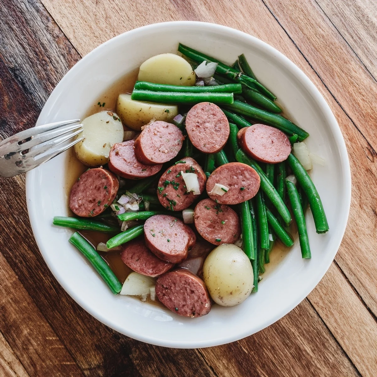 Slow cooker Crockpot Kielbasa and Green Beans featuring smoky sausage slices and tender potatoes in savory broth