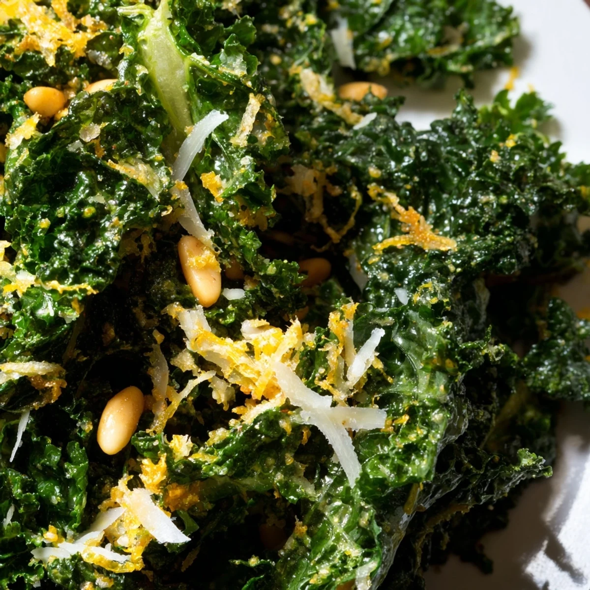Crispy garlic lemon Parmesan kale salad topped with shaved cheese and toasted pine nuts