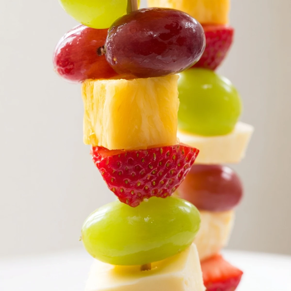 Fruit and cheese kabobs featuring alternating cubes of creamy Monterey Jack cheese with fresh juicy strawberries and grapes