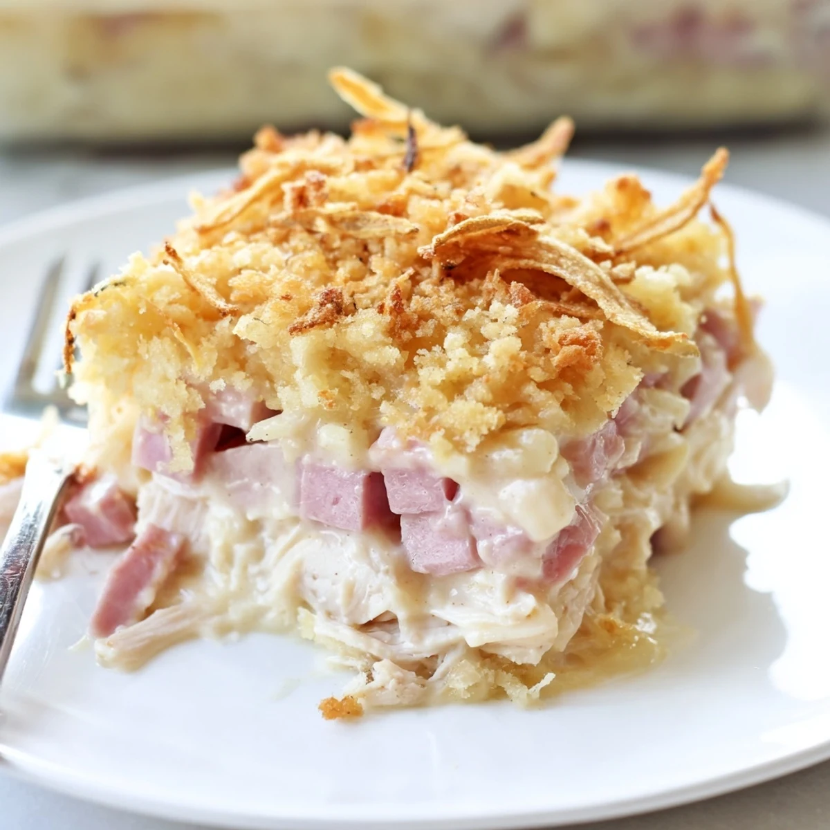 Golden-topped Chicken Cordon Bleu Casserole bubbling with creamy Dijon sauce.
