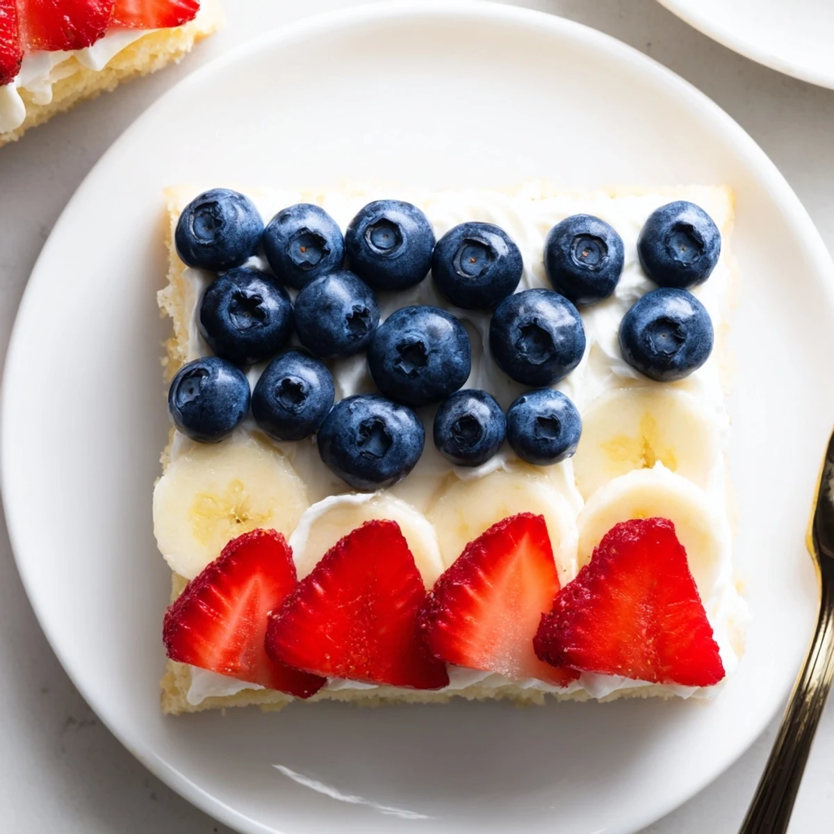 Chilled American Flag Fruit Pizza sliced ready for summer picnics, creamy frosting  