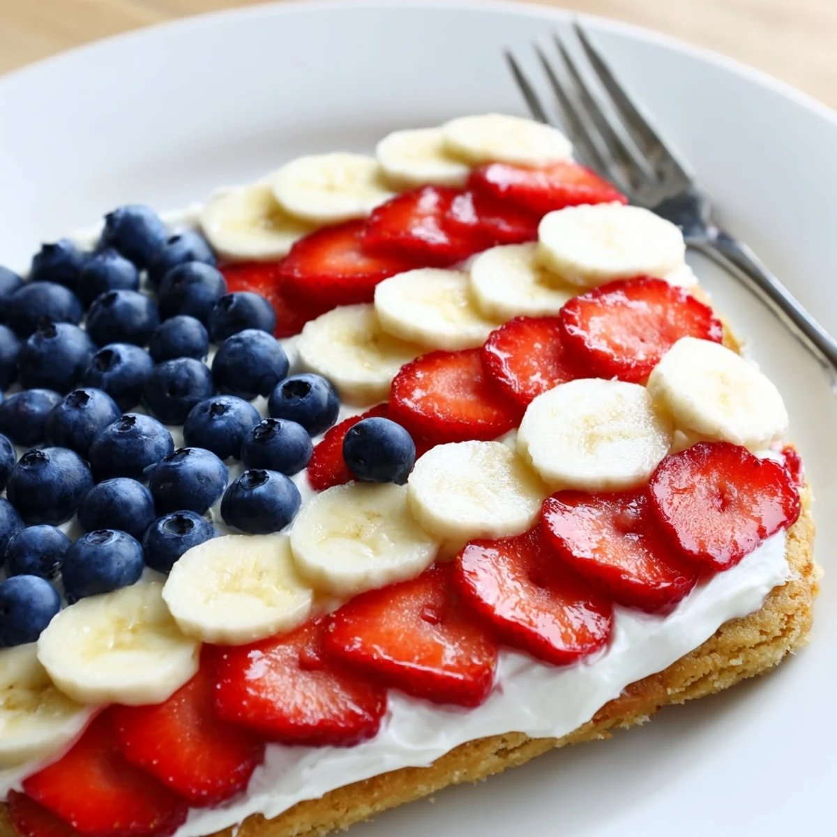 American Flag Fruit Pizza on cookie crust, glossy blueberries and sliced strawberries  