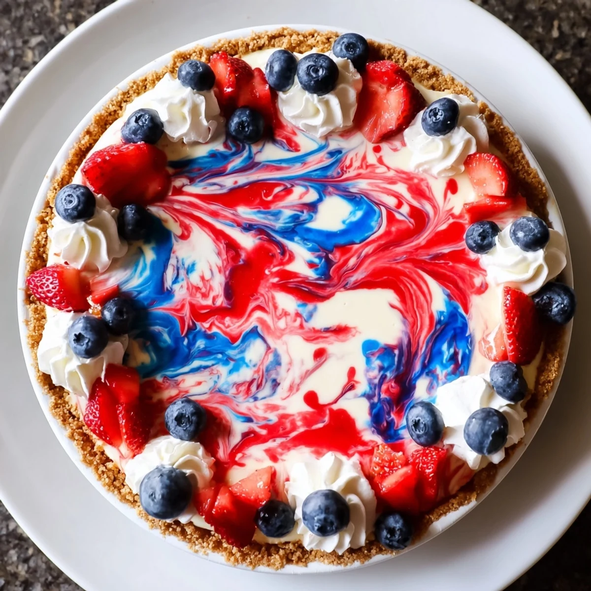 Slice of Patriotic Red White And Blue Swirl Pie on plate, creamy, fruity