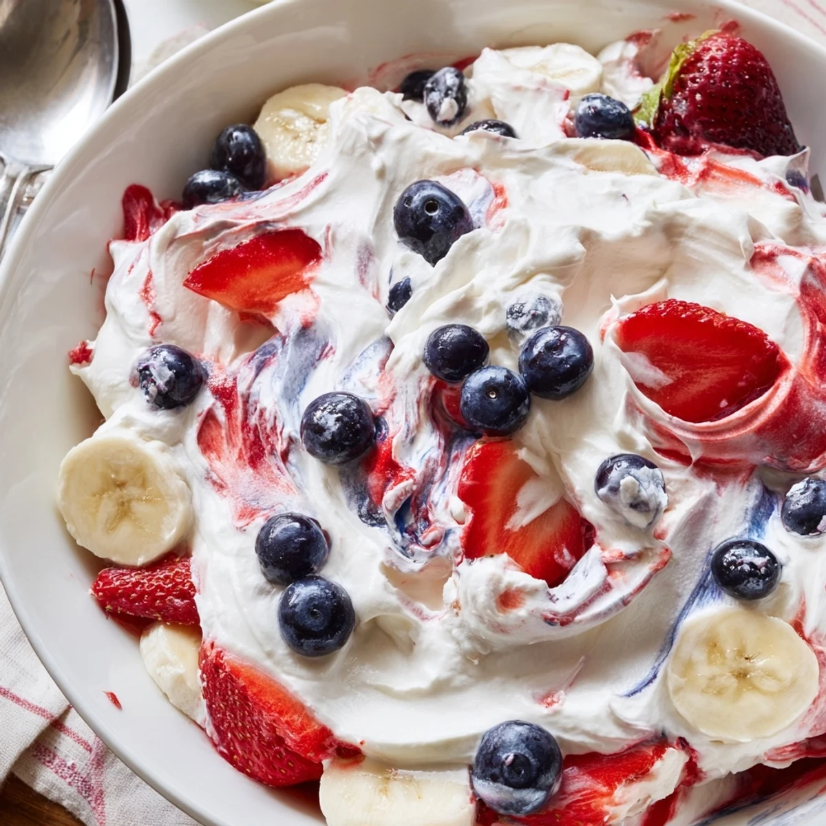 Patriotic Red White And Blue Cheesecake Salad served cold, fluffy cream, berry topping