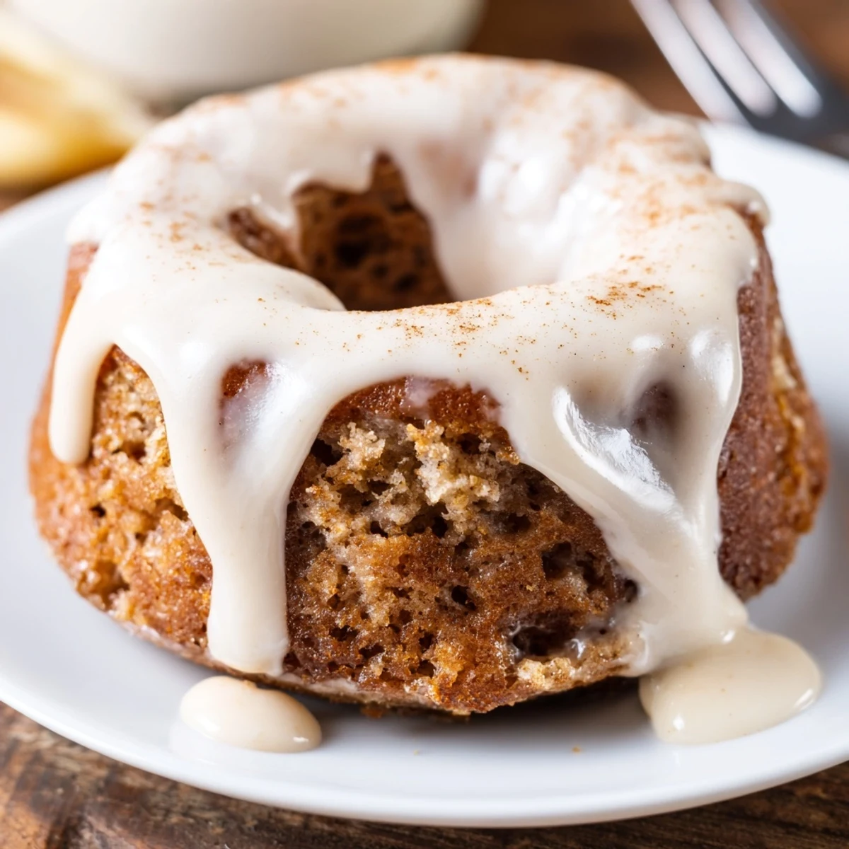 Warm, freshly baked Banana Donuts with glossy vanilla glaze cooling on rack