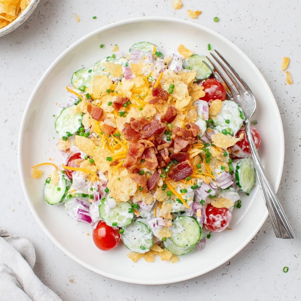 Heaping Cucumber Ranch Crack Salad with smoky bacon, crunchy kettle-chip topping