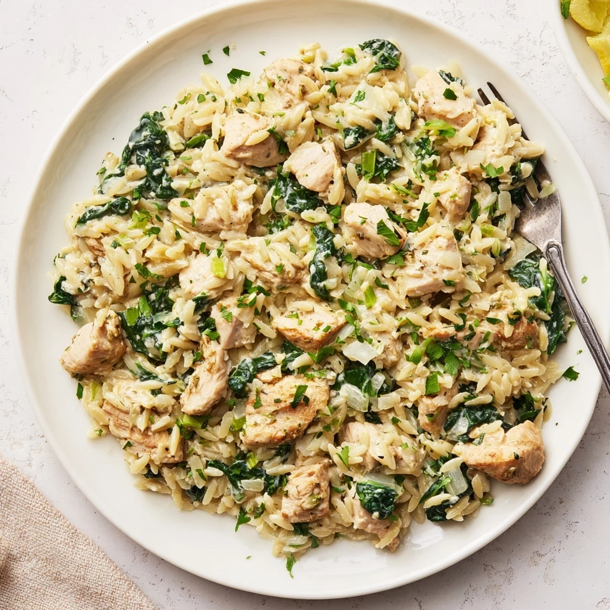 Savory one pan Boursin chicken orzo featuring melty cheese, fresh herbs, and vibrant green spinach