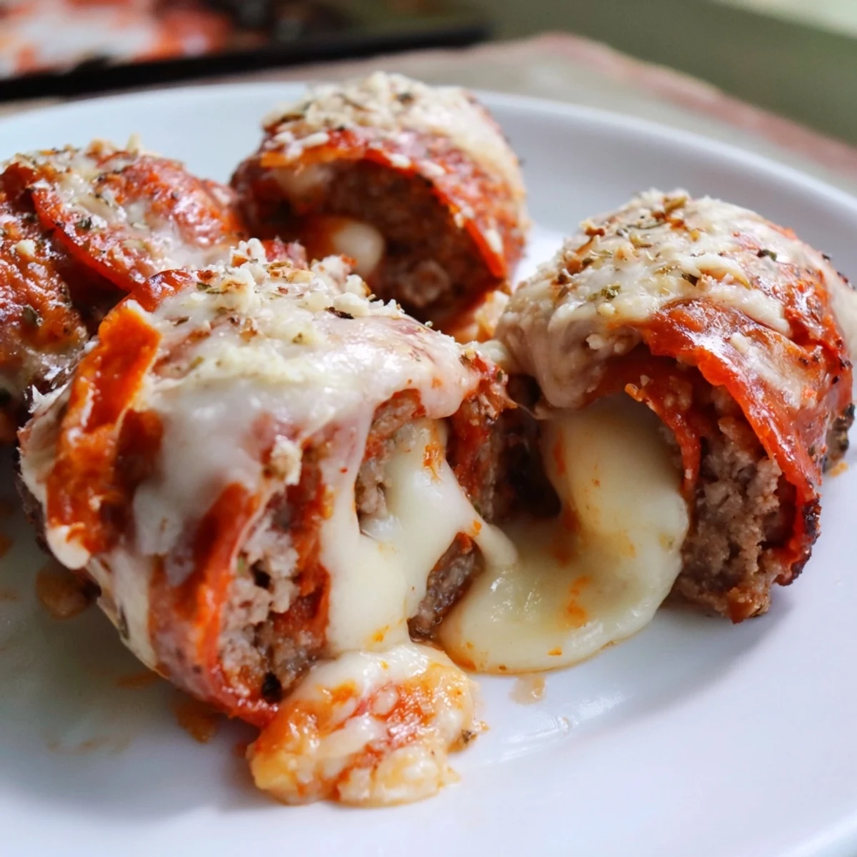 Easy keto beef pepperoni cheese roll ups appetizer served with marinara dipping sauce