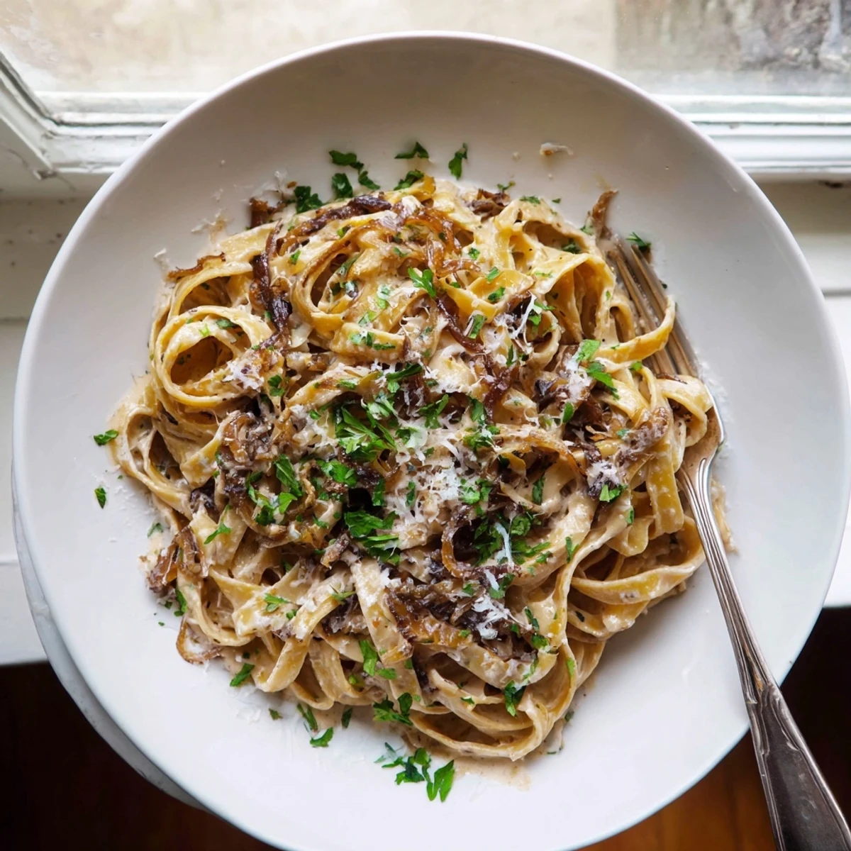 Creamy fettuccine with sweet caramelized onions swimming in a rich white cream sauce