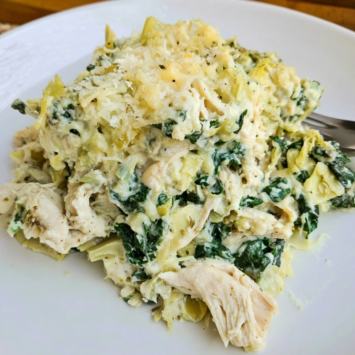 Baked Spinach Artichoke Chicken Casserole served hot, topped with crunchy breadcrumbs