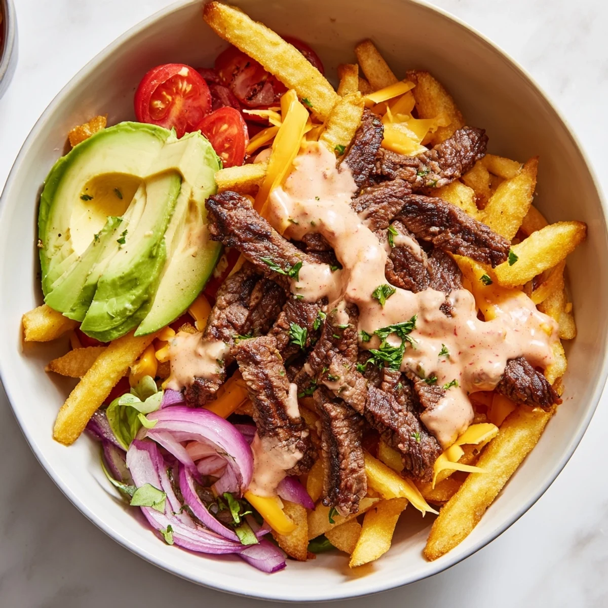 Crispy golden fries topped with tender seared steak strips and fresh vegetables